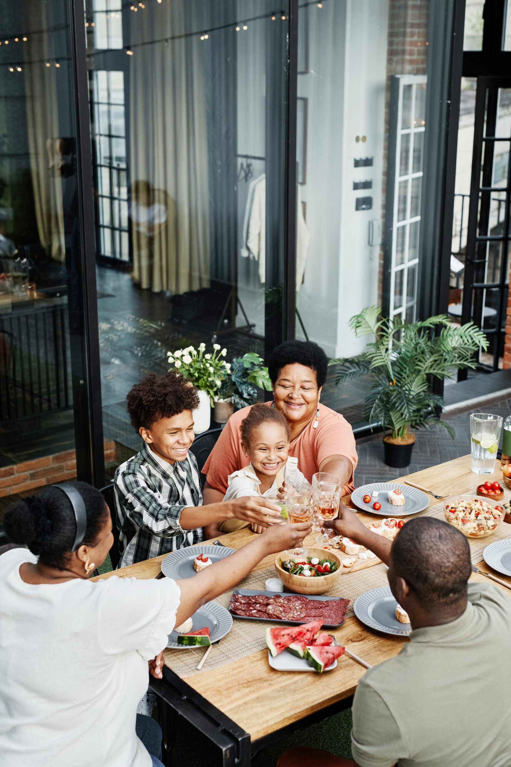 Family celebrating outdoors over a chef-prepared dinner