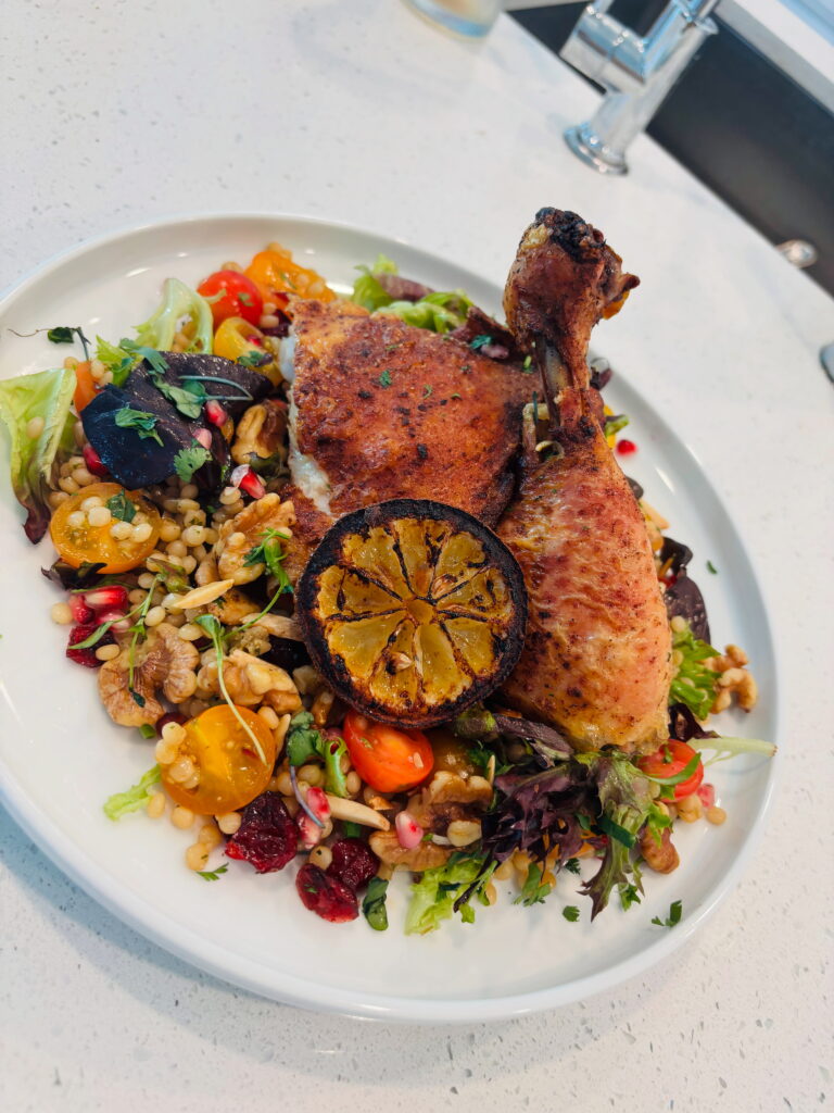 Roasted chicken, pearl couscous walnut and tomato salad, charred lemon vinaigrette