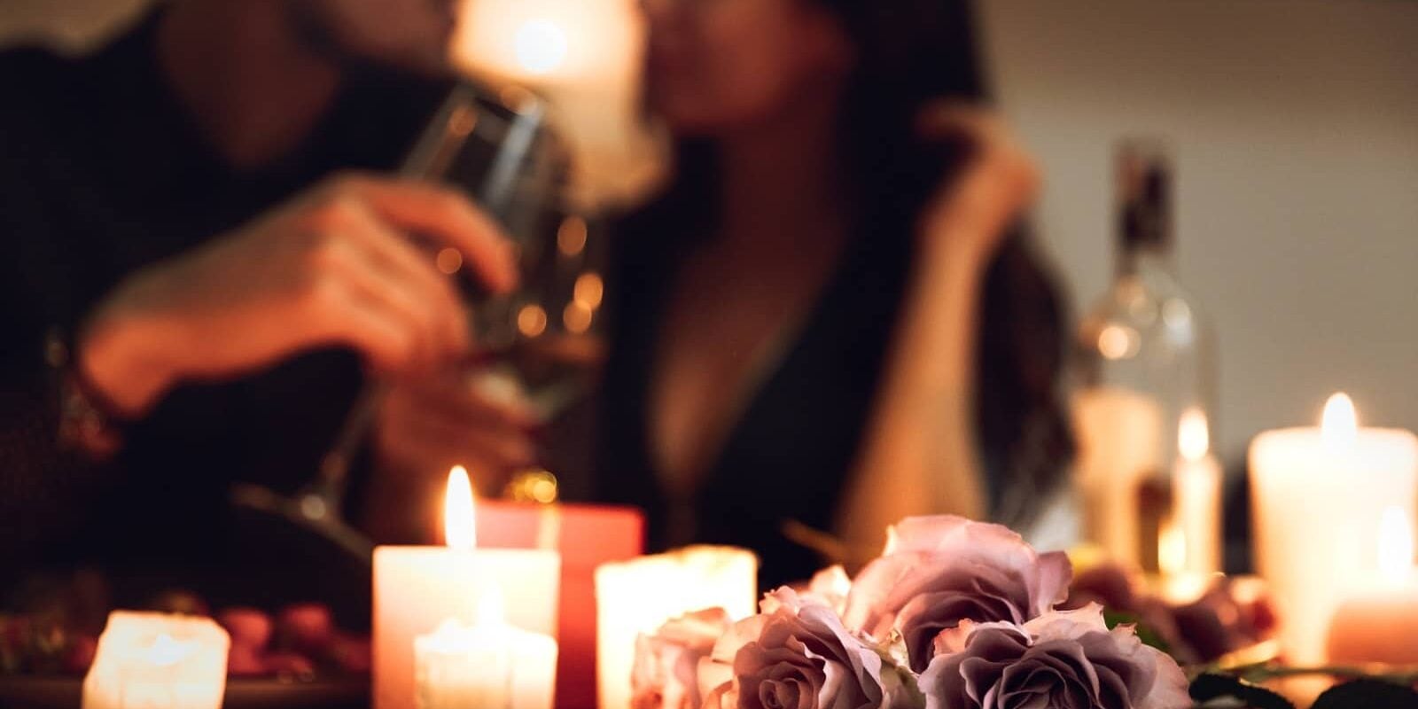 Couple enjoying candlelit anniversary dinner